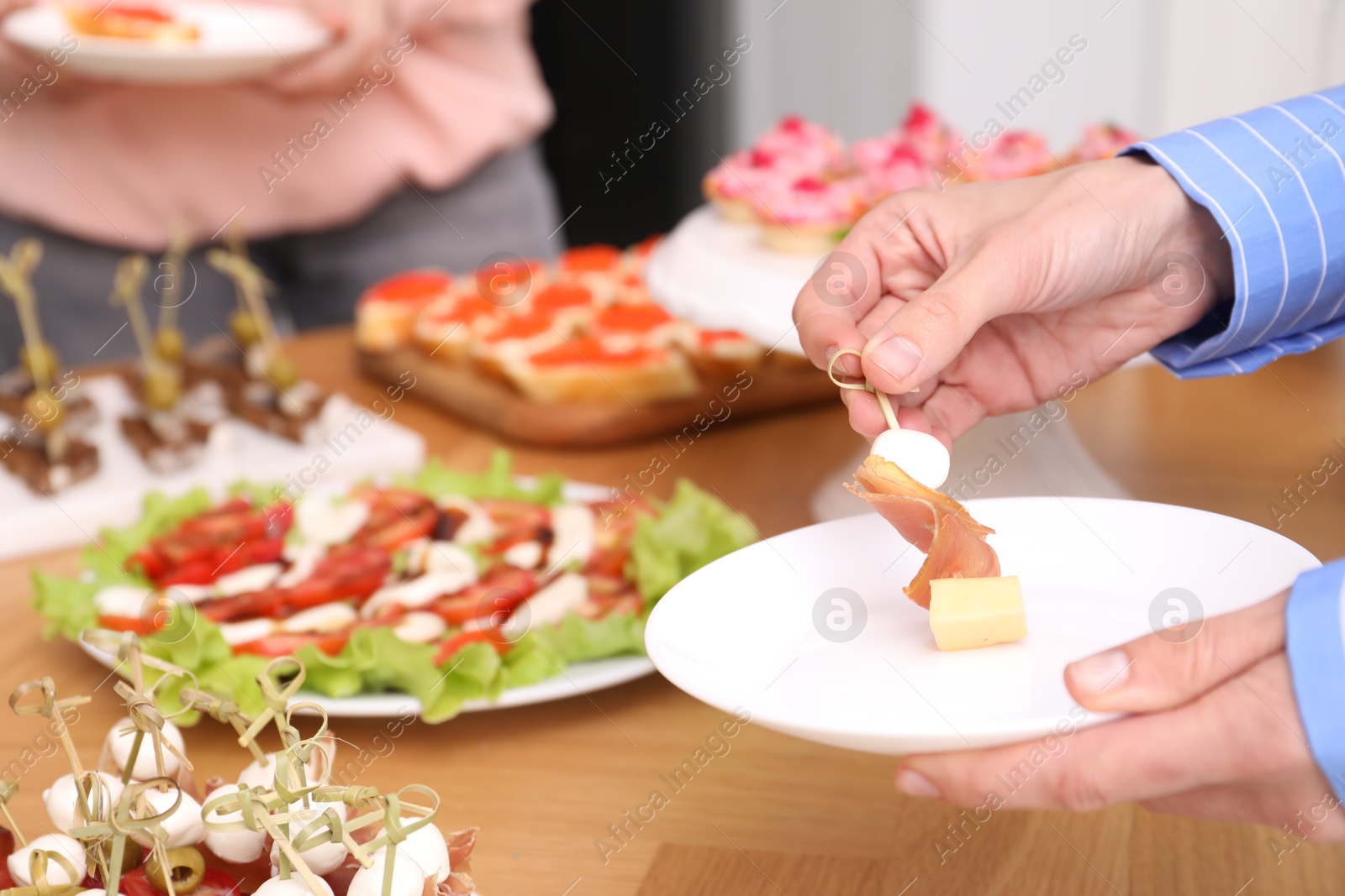 Buffet menu. Woman taking tasty canape from table, closeup Photo of Buffet menu. Woman taking tasty canape from table, closeup