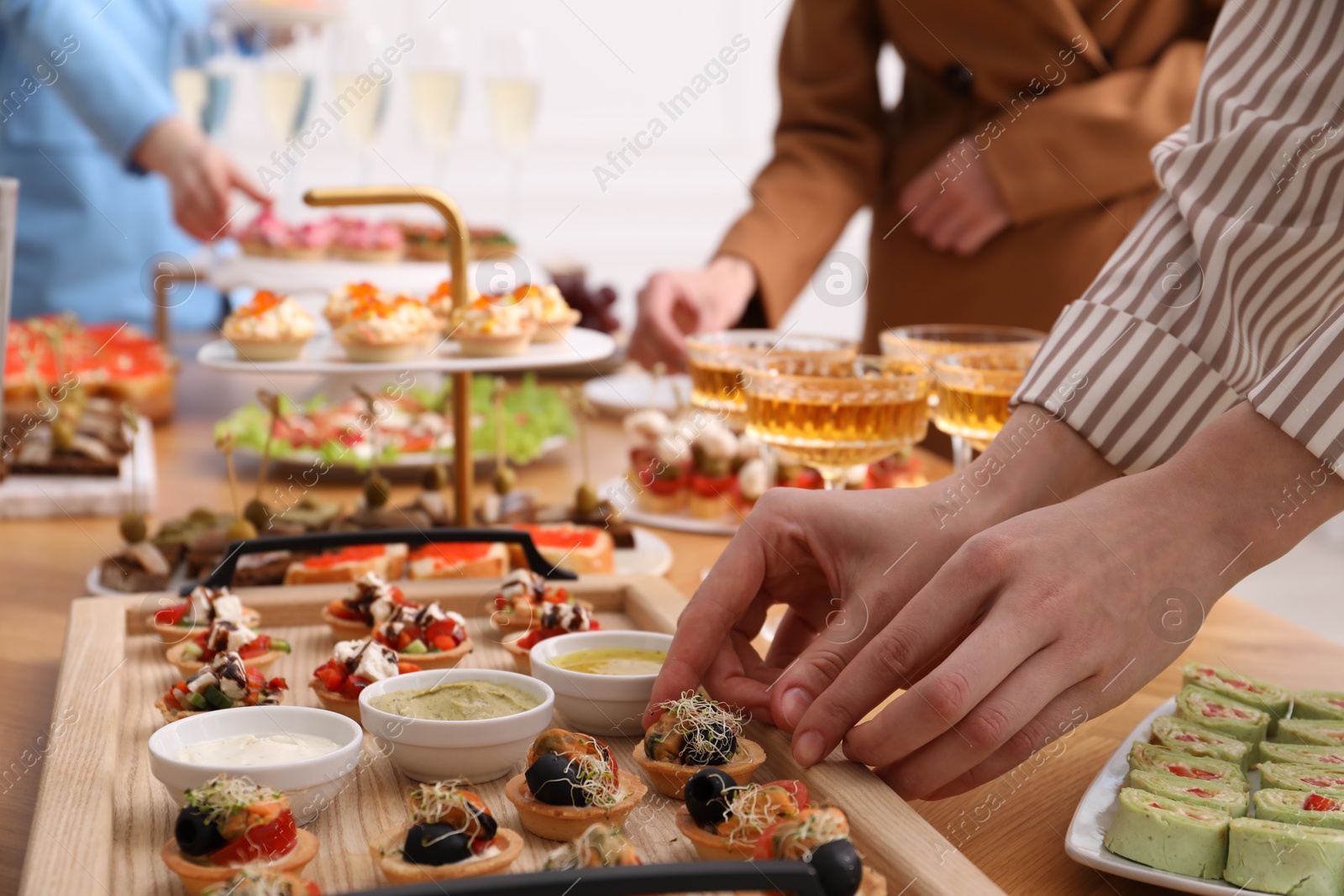 People with different appetizers at buffet, selective focus Photo of People with different appetizers at buffet, selective focus