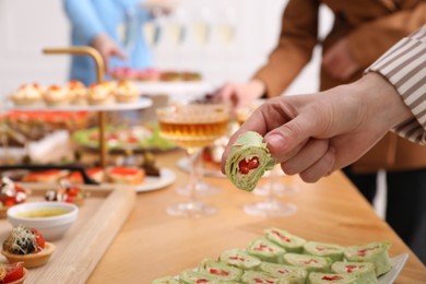 Photo of People with different appetizers at buffet, selective focus