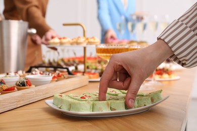 Photo of People with different appetizers at buffet, selective focus