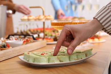 Photo of People with different appetizers at buffet, selective focus