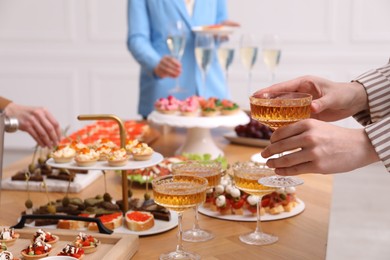 Photo of People with different appetizers at buffet, selective focus