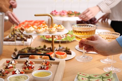 Photo of People with different appetizers at buffet, selective focus
