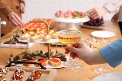 Photo of People with different appetizers at buffet, selective focus