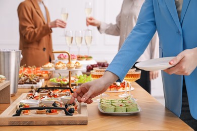 Photo of People with different appetizers at buffet, selective focus