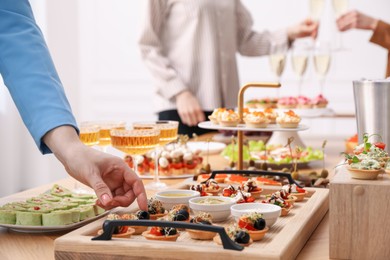 Photo of People with different appetizers at buffet, selective focus