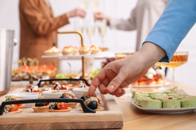Photo of People with different appetizers at buffet, selective focus