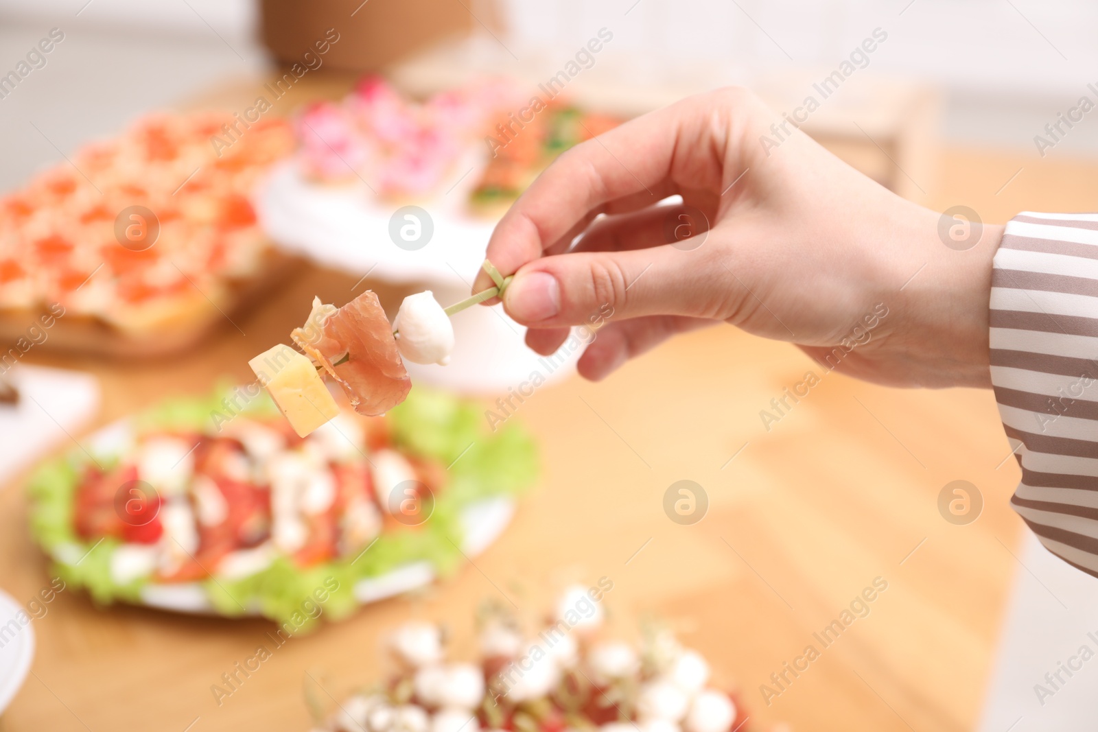 Buffet menu. Woman taking tasty canape from table, closeup Photo of Buffet menu. Woman taking tasty canape from table, closeup