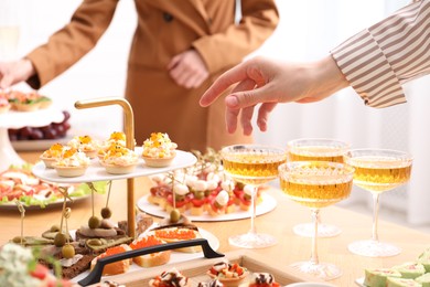 Photo of Buffet menu. Woman choosing appetizer at table, closeup