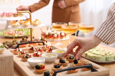Photo of People with different appetizers at buffet, selective focus
