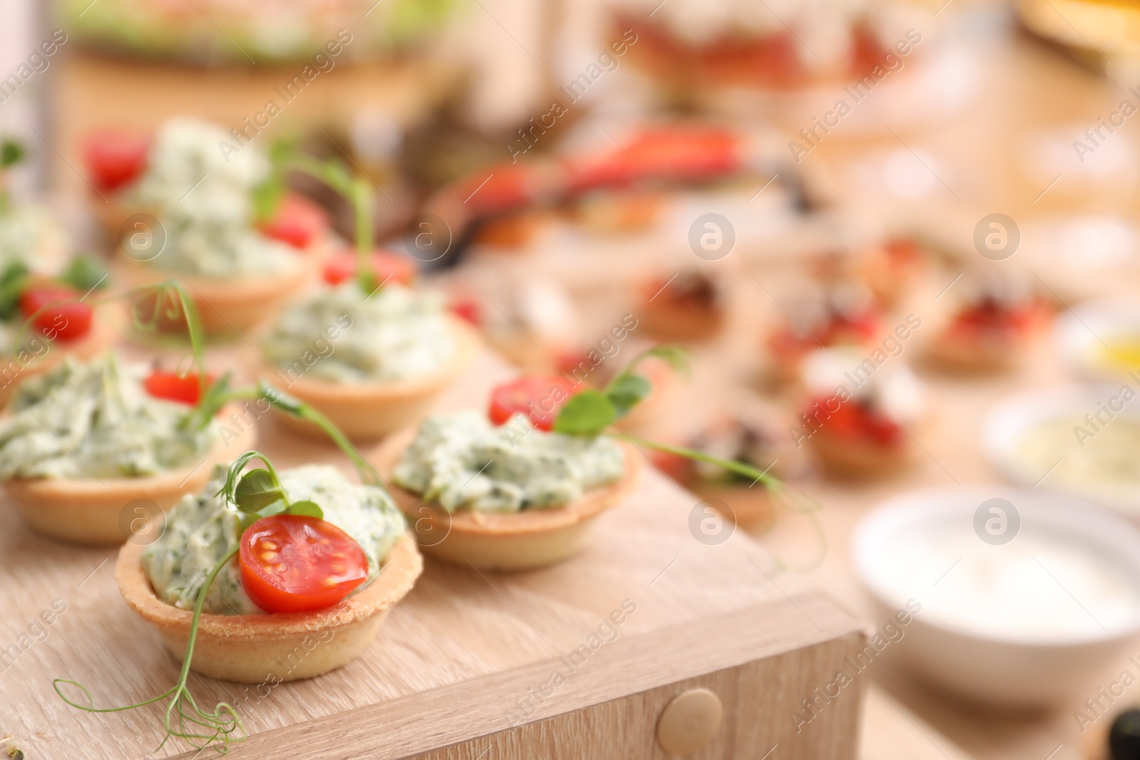 Buffet menu. Tasty stuffed tartlets on stand, closeup Photo of Buffet menu. Tasty stuffed tartlets on stand, closeup