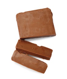 Photo of Pieces of tasty chocolate butter isolated on white, top view