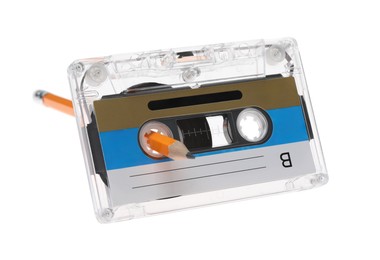 Photo of Rewinding audio cassette with pencil isolated on white