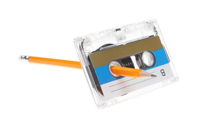 Photo of Rewinding audio cassette with pencil isolated on white