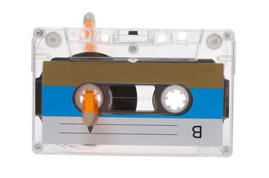 Photo of Rewinding audio cassette with pencil isolated on white