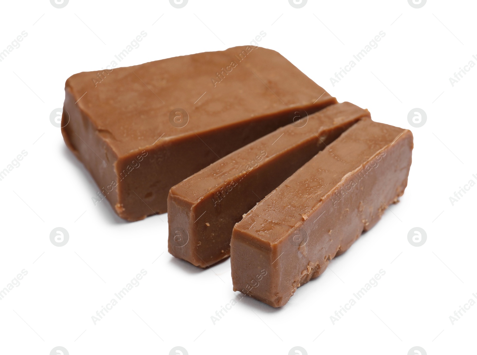 Pieces of tasty chocolate butter isolated on white Photo of Pieces of tasty chocolate butter isolated on white