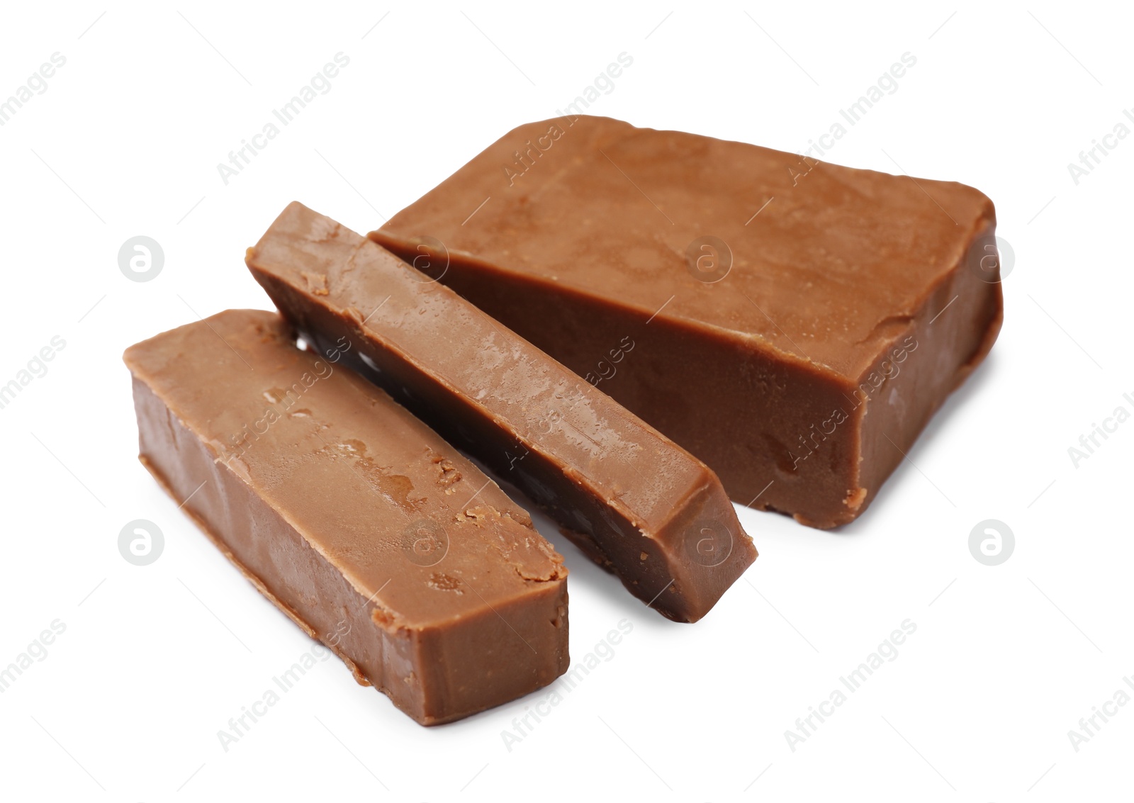 Pieces of tasty chocolate butter isolated on white Photo of Pieces of tasty chocolate butter isolated on white
