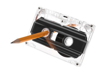 Photo of Rewinding audio cassette with pencil isolated on white