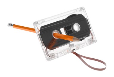 Photo of Rewinding audio cassette with pencil isolated on white