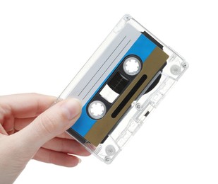 Photo of Woman holding audio cassette with blank label on white background, closeup