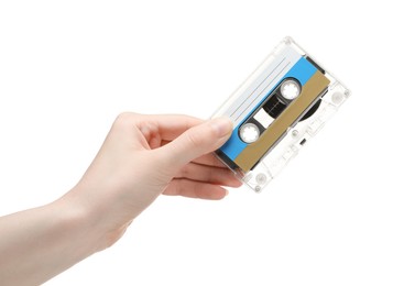 Photo of Woman holding audio cassette with blank label on white background, closeup
