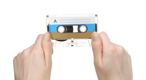 Photo of Woman holding audio cassette with blank label on white background, closeup