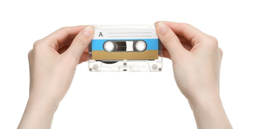 Photo of Woman holding audio cassette with blank label on white background, closeup