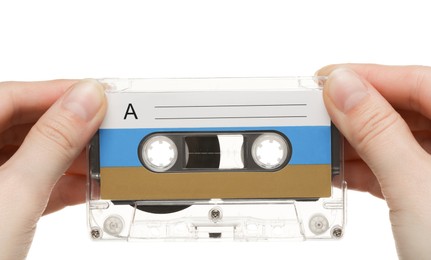 Photo of Woman holding audio cassette with blank label on white background, closeup