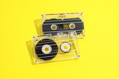 Photo of Audio cassettes with magnetic tapes on yellow background