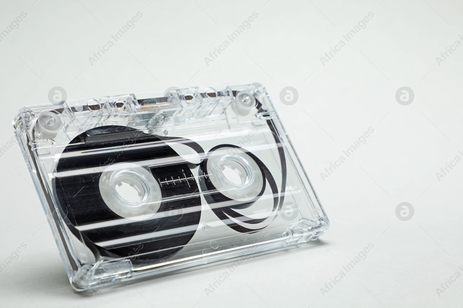 One audio cassette in air on light grey background, closeup Photo of One audio cassette in air on light grey background, closeup