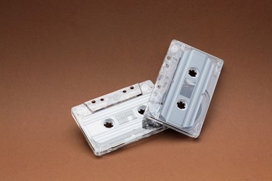 Photo of Audio cassettes with magnetic tapes on brown background