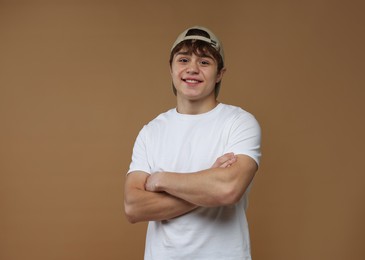 Photo of Portrait of teenage boy on brown background
