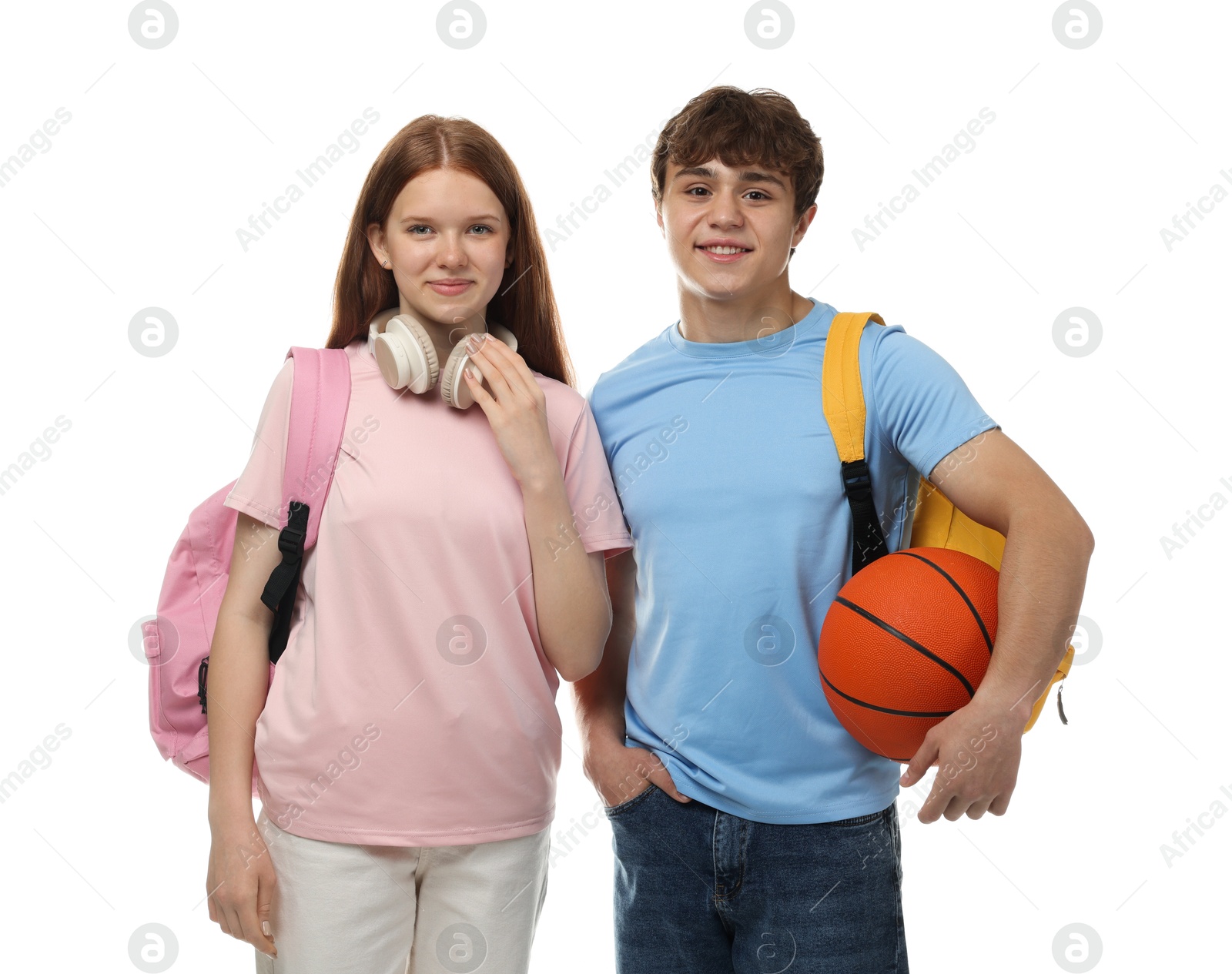 Teenage girl and boy with basketball on white background Photo of Teenage girl and boy with basketball on white background