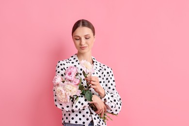 Photo of Woman with beautiful bouquet of peonies on pink background