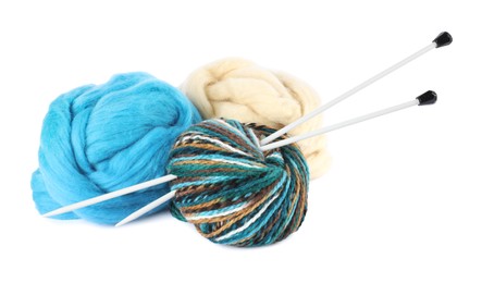 Photo of Felting wool, knitting yarn and needles isolated on white