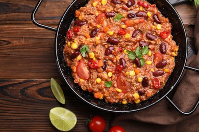 Photo of Tasty chili con carne in baking dish on wooden table, flat lay
