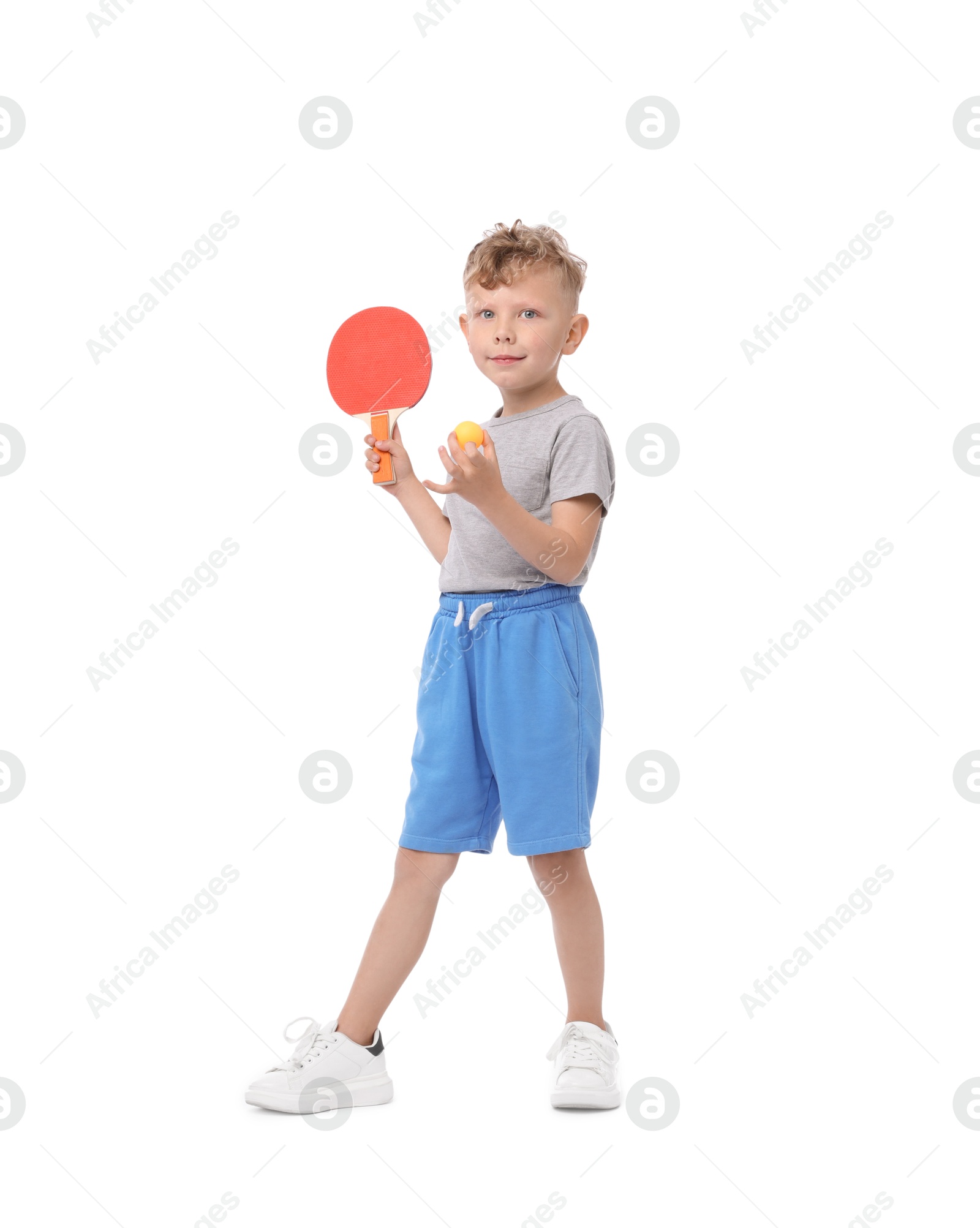 Photo of Little boy with ping pong racket and ball on white background