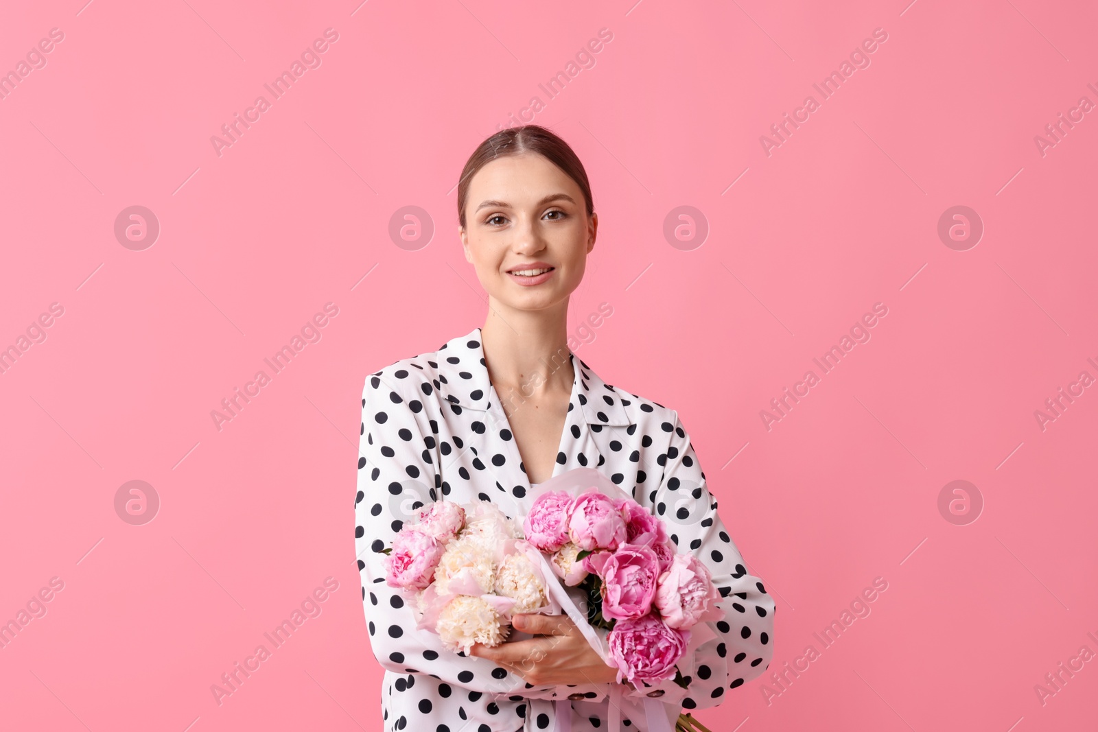 Woman with beautiful bouquets of peonies on pink background Photo of Woman with beautiful bouquets of peonies on pink background