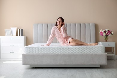 Photo of Woman on bed with orthopedic mattress at home