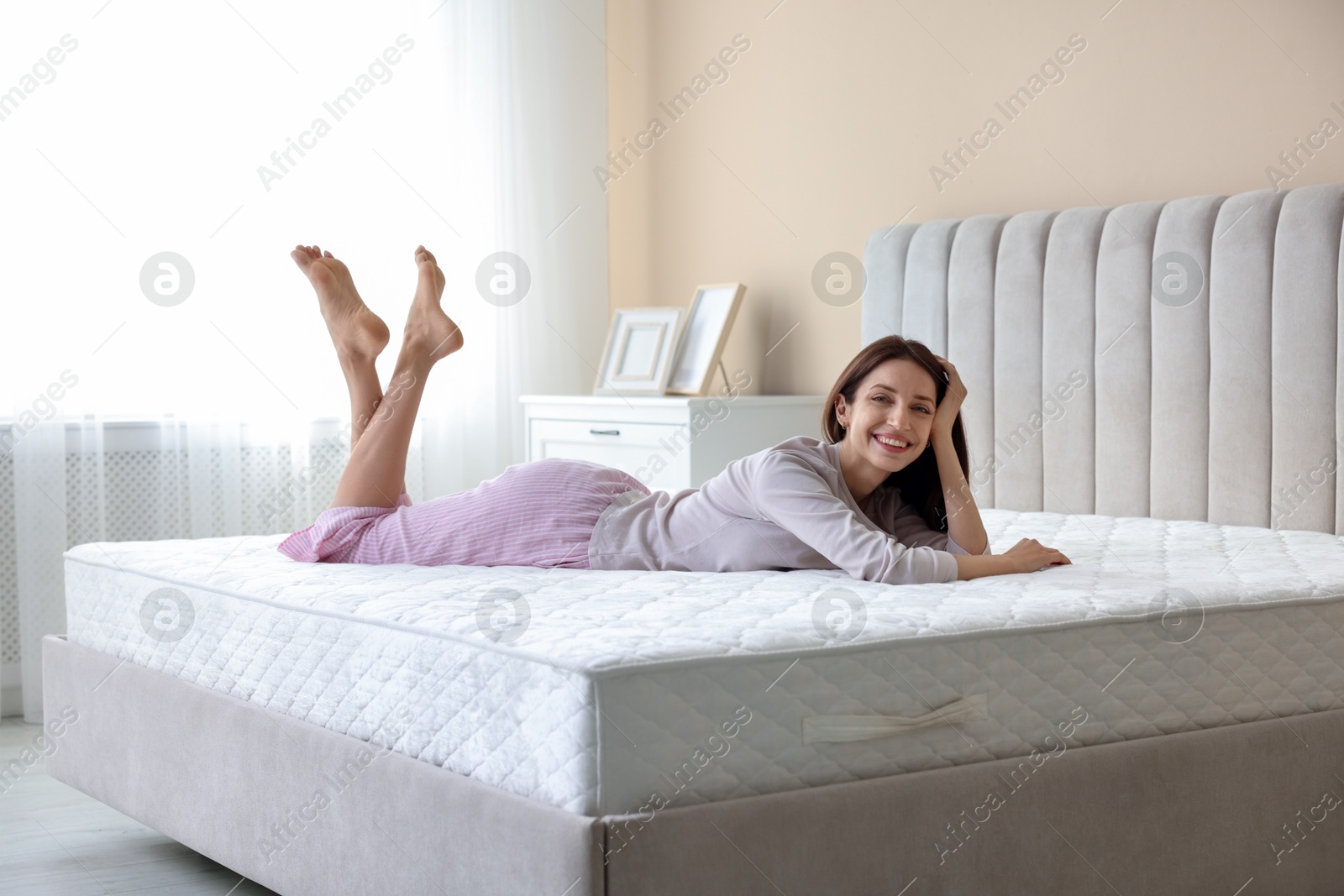 Woman lying on bed with orthopedic mattress at home Photo of Woman lying on bed with orthopedic mattress at home