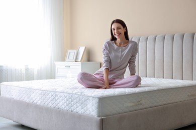 Photo of Woman on bed with soft mattress at home