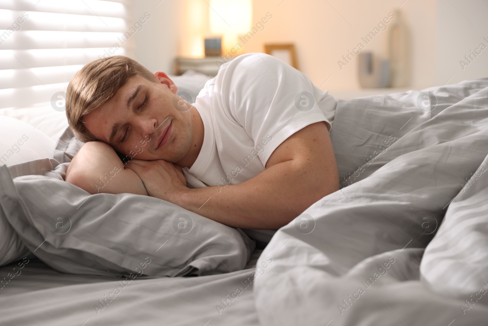 Young man sleeping on bed with soft mattress at home Photo of Young man sleeping on bed with soft mattress at home