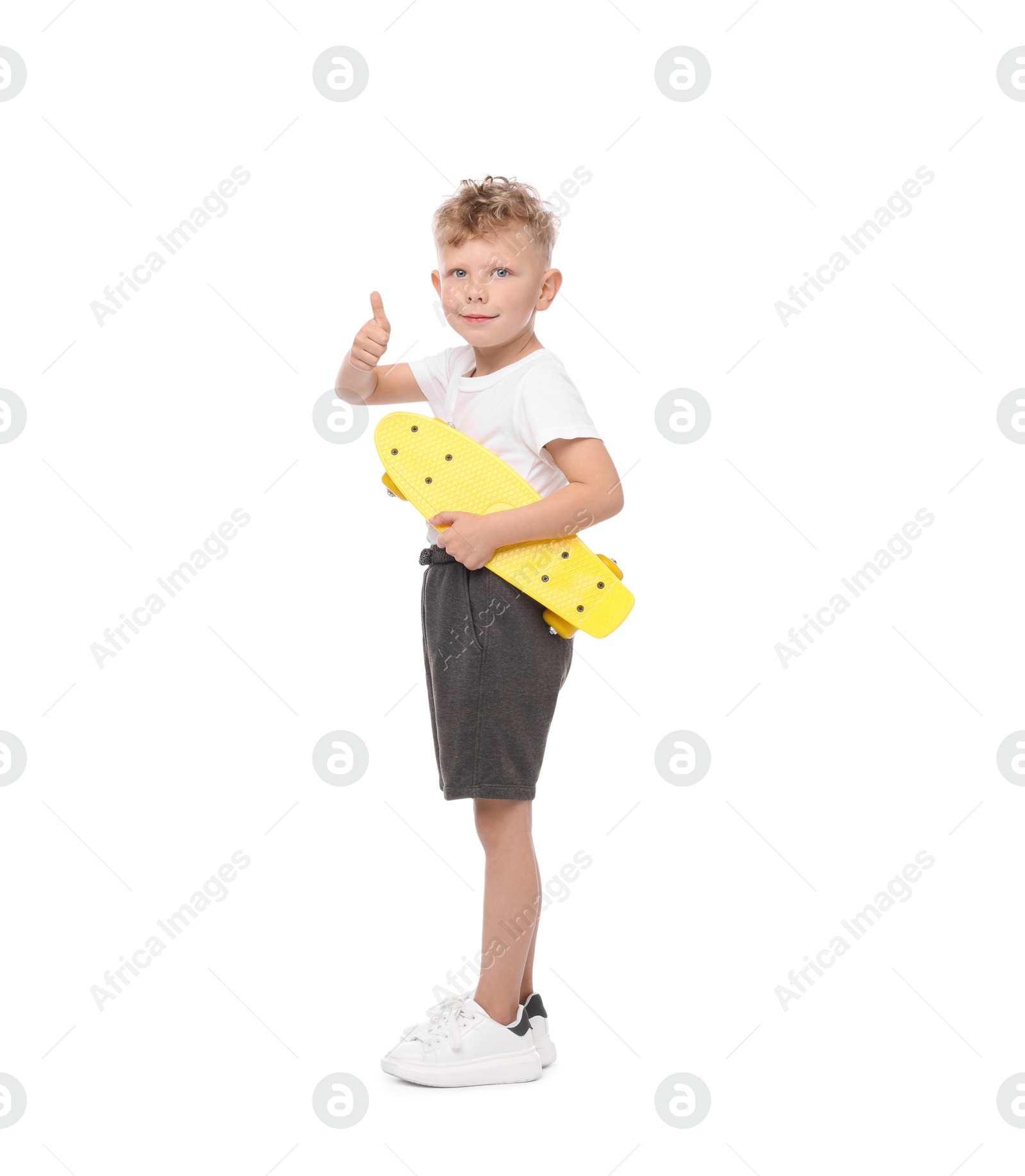 Little boy with penny board showing thumbs up \on white background Photo of Little boy with penny board showing thumbs up \on white background