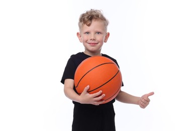 Photo of Little boy with basketball ball showing thumbs up on white background