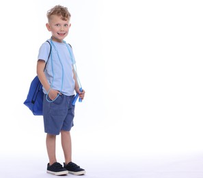 Photo of Little boy with jump rope and sports string bag on white background, space for text