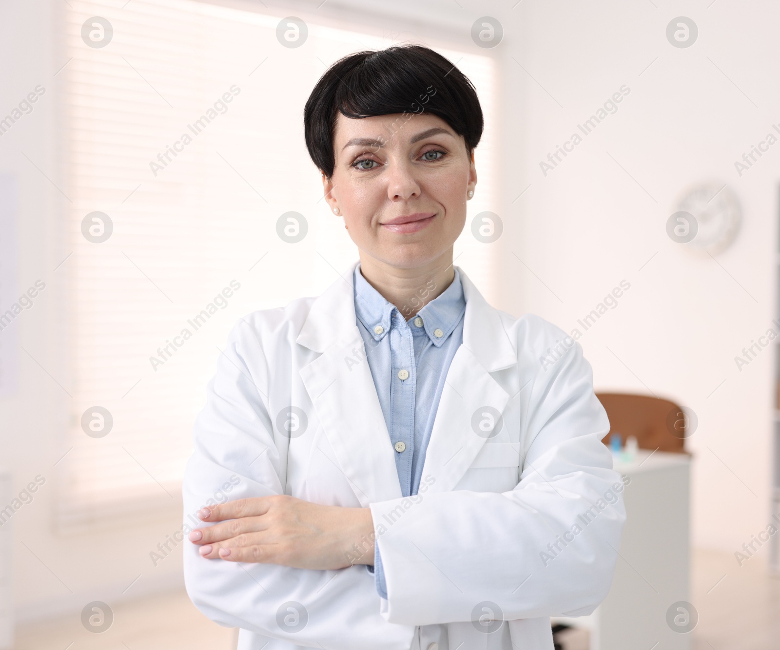 Portrait of professional ophthalmologist with crossed arms in clinic Photo of Portrait of professional ophthalmologist with crossed arms in clinic