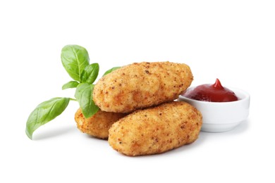 Photo of Tasty fried croquettes, basil and sauce isolated on white