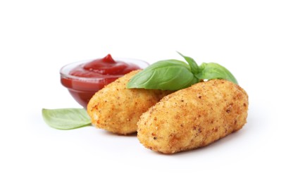 Photo of Tasty fried croquettes, basil and sauce isolated on white