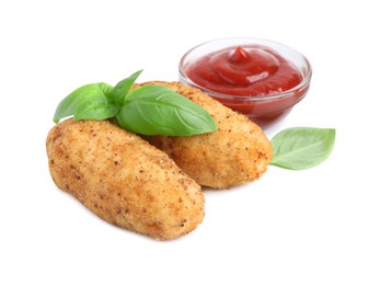 Photo of Tasty fried croquettes, basil and sauce isolated on white