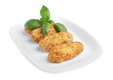 Photo of Tasty fried croquettes and basil isolated on white